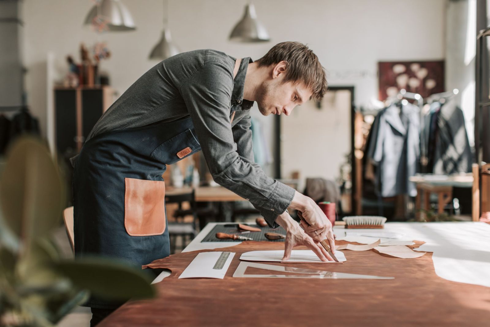 A leather workshop bench mid-project — where all of this vocabulary gets used daily